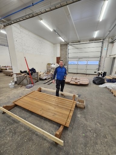Simon beside a sauna floor during construction