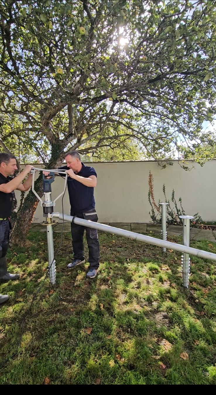 Four garden sauna ground screws positioned with the powered installation drill