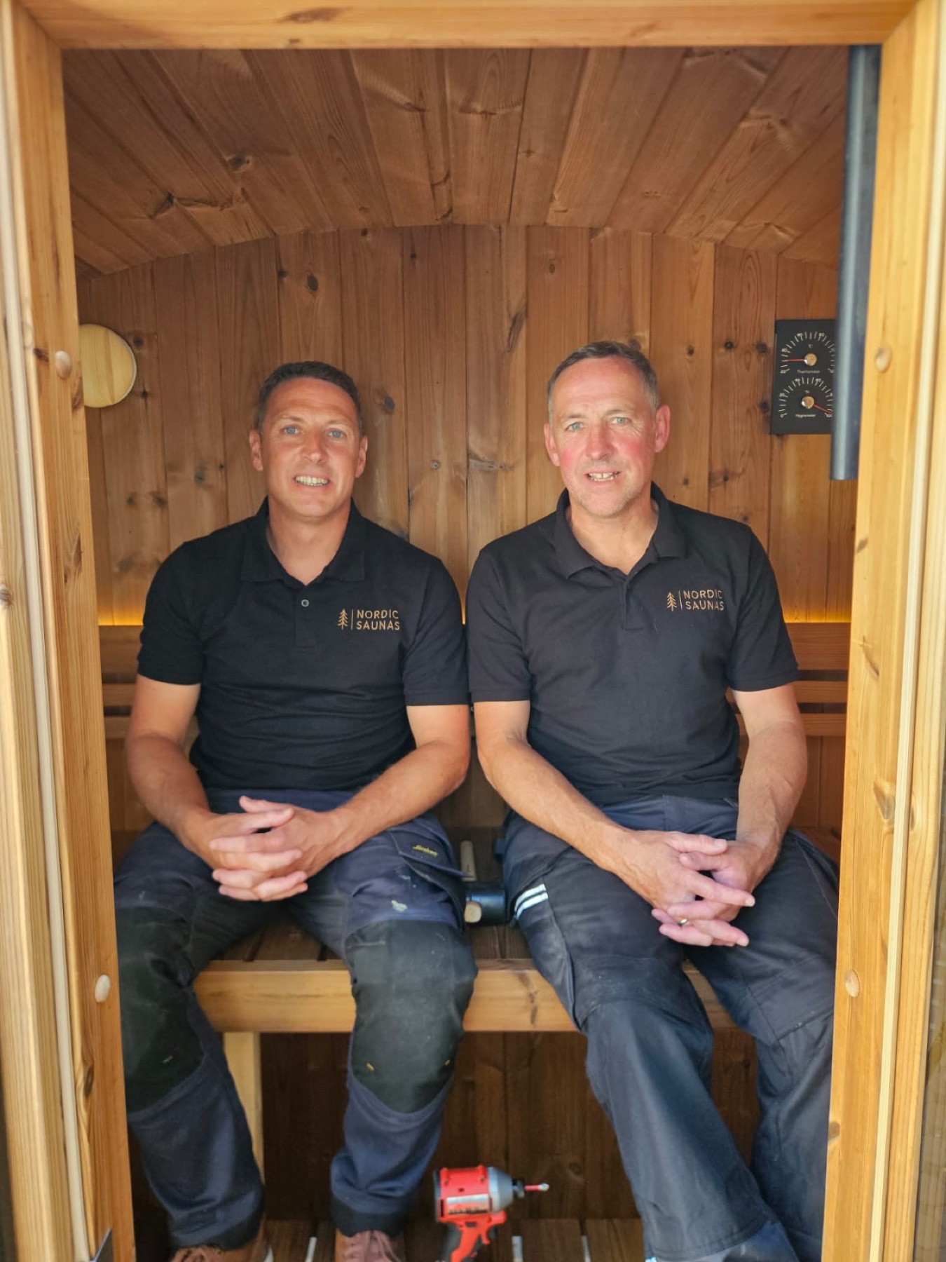 Simon and Jason of Nordic Saunas seated inside a timber sauna